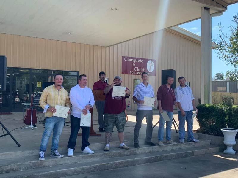 Men graduating rehab